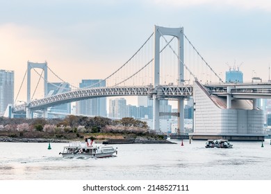 Tokyo, Japan - April, 2022: Landscape Of Rainbow Bridge, The Most Famous Bridge In Tokyo And Odaiba Area In A Cloudy Day