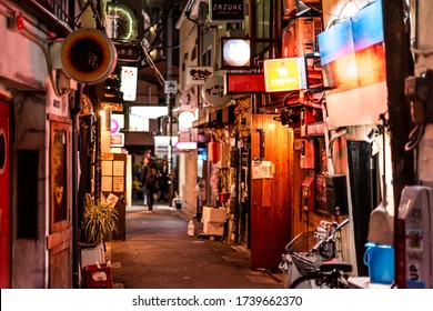 Tokyo, Japan - April 3, 2019: Shinjuku Ward Downtown With Golden Gai Narrow Alley Lane Street With Izakaya Restaurants At Night And Signs