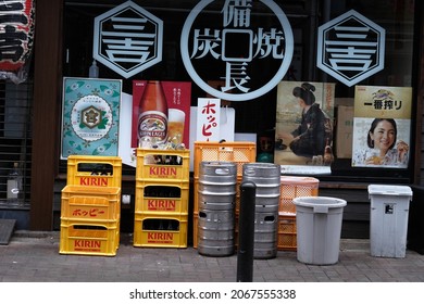 Tokyo, Japan - August 22 2021: Plastic yellow beer crates in front of a restaurant.