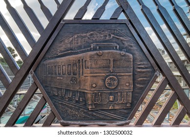 TOKYO, JAPAN - August 23 2018: Engraving on metal representing the famous Hokutosei train on the Shimogoindenbashi Bridge that reaches the Nippori and Yanaka neighborhoods in Tokyo.
