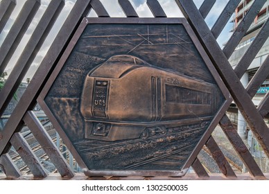 TOKYO, JAPAN - August 23 2018: Engraving on metal representing the Super Hitachi train on the Shimogoindenbashi Bridge that reaches the Nippori and Yanaka neighborhoods in Tokyo.