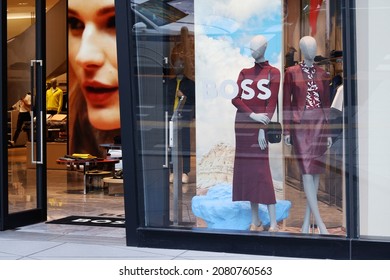 TOKYO, JAPAN - August 25, 2021: Front Of Hugo Boss Store In Tokyu Plaza Shopping Mall In Ginza With Mannequins In The Window And A Face On A Screen.