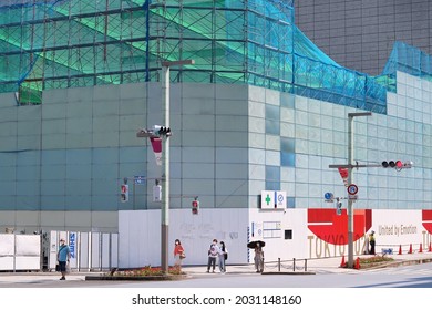 TOKYO, JAPAN - August 26, 2021: View Of Street Corner In Tokyo's Nihonbashi Area With Tokyo 2020 Design Fence In Front Of A Demolition Site Where Nishikawa Store Used To Be.  