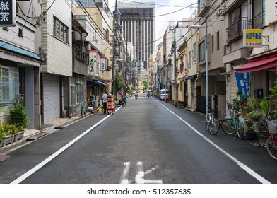 Tokyo, Japan - August 29, 2016: Tokyo Street With Small Business Shops On Early Morning. Text On Banners Advertises Real Estate Agency, Paper Store, Bar And Cafes