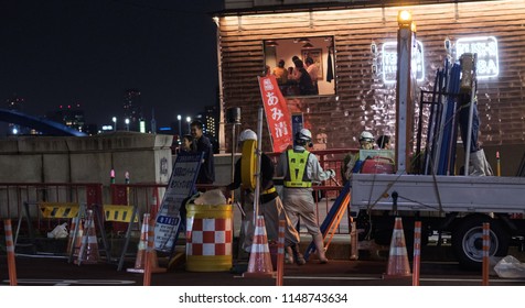 TOKYO, JAPAN - AUGUST 3RD, 2018. Road Construction Crew Working At Night In The Street Of Asakusa At Night.