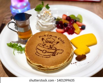 TOKYO, JAPAN - Ca. March 2018 - Food At The Pokémon Cafe In Nihonbashi, Pancakes With The Pokémon Café Logo And A Cookie Shaped Like A Pikachu Tail