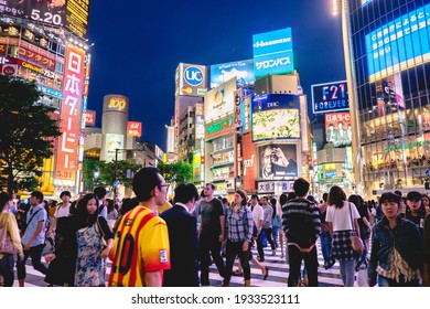 Tokyo, Japan - Circa 2015: Colorful Panoramic View Of The Famous Shibuya Crossing At Tokyo Downtown With A Crowd Of People In The Night