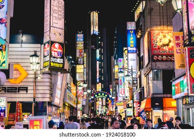 Tokyo, Japan - Circa 2015: People walking, night light, neons, buildings, advertisings, restaurants and stores at Shinjuku in the night