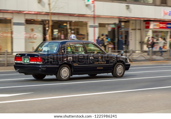 TOKYO, JAPAN - CIRCA, 2018: Classic black taxi car\
on the street of Tokyo
