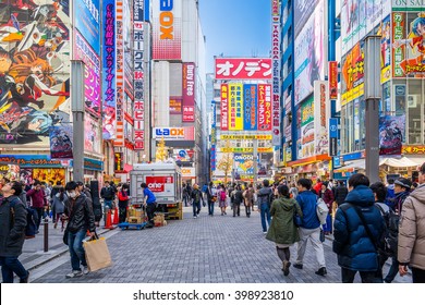 TOKYO, JAPAN - CIRCA JANUARY, 2016: Crowds pass below colorful signs in Akihabara. The electronic district has evolved into a shopping area for video games, anime, manga, computer January, 2016 Tokyo