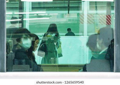 TOKYO, JAPAN - Dec.05 2018 : Asia Business Woman Through Train's Glass Window In Tokyo, Japan