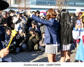 Tokyo, Japan - December 2017: Cosplayer Surrounded By Photographers At Comiket 93