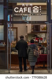 TOKYO, JAPAN - DECEMBER 21ST, 2017. Old Japanese Couple Entering A Cafe At Kitte Shopping Mall.