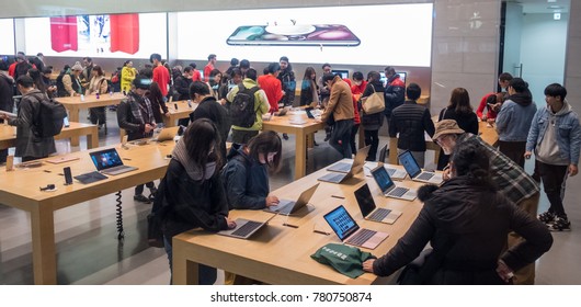 TOKYO, JAPAN - DECEMBER 21ST, 2017. Customers In Apple Store In Omotesando Ar Night.