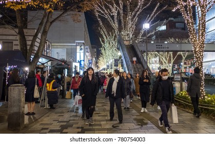 TOKYO, JAPAN - DECEMBER 21ST, 2017. Crowd Of People Walking And Enjoying The Winter Illuminated Sidewalk Street Of Omotesando At Night.