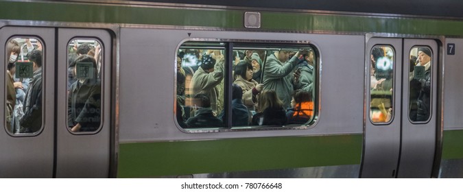 TOKYO, JAPAN - DECEMBER 21ST, 2017. Crowded Commuters In Japan Railway Yamanote Train At Night.