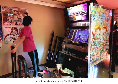 TOKYO - JAPAN - DECEMBER 26, 2015: A Boy Plays Dance Dance Revolution, A Konami Arcade Game, Inside Taito Arcade Store.