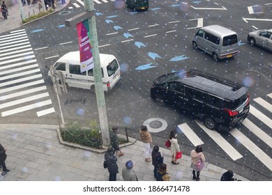 TOKYO, JAPAN - December 3, 2020: Overhead View Of A Large Junction In Tokyo's Ginza Area. Some Motion Blur. Photo Taken Through LED-embedded Window.