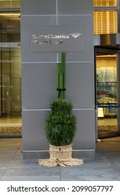 TOKYO, JAPAN - December 31, 2021:  Entrance to Merrill Lynch Bank of America office building in Tokyo's Nihonbashi area with Kadomatsu New Year decorations in front of it.