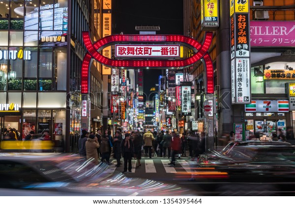 TOKYO, JAPAN - FEB 2019\
: Crowds Undefined people walking around Kabukicho which is one\
Shopping neon street of shinjuku area at night time on Febuary 15,\
2019 in Tokyo, Japan.