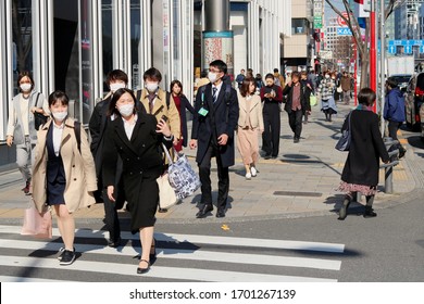 TOKYO, JAPAN - February 13, 2020: A Busy Street In Tokyo's Omotesando In Front Of A Dyson Store. Some People Are Wearing Face Masks During The Coronavirus Outbreak. Some Motion Blur.