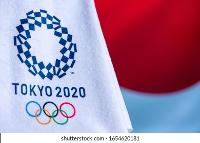 TOKYO, JAPAN, FEBRUARY. 14. 2020: Tokyo 2020 Olympic Logo, Waving Japan Flag In Background