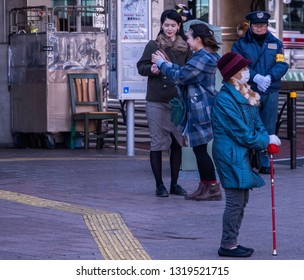 TOKYO, JAPAN - FEBRUARY 21ST, 2019. Elderly Woman Waiting For A Bus At A Shibuya Bus Stop During Winter Season.