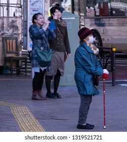 TOKYO, JAPAN - FEBRUARY 21ST, 2019. Elderly Woman Waiting For A Bus At A Shibuya Bus Stop During Winter Season.