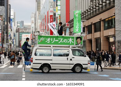 TOKYO, JAPAN - February 22, 2020: A politician gets ready to make a speech from the roof of campaign vehicle belonging to the Olive Party parked in Tokyo's Ginza area.