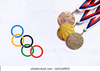 TOKYO, JAPAN, JANUARY. 20. 2020: Medal Set, Gold Silver And Bronze, White Background, Olympic Circles