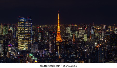 Tokyo, Japan - January, 2020: A picture of the Tokyo Tower and its surrounding cityscape at night.