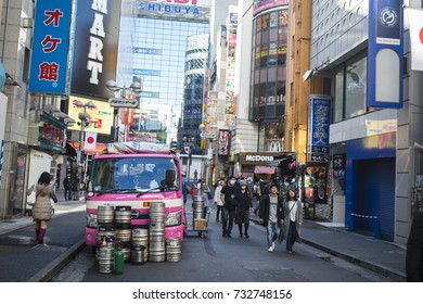 TOKYO - JAPAN - JANUARY 4, 2017. A Pink Truck With Barrels Is Parked In The Streets Of Shinjuku While People Walk Around. Shinjuku Is A Special Ward In Tokyo, Japan.