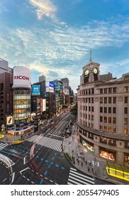 Tokyo, Japan - July 05 2021: Bird's-eye View Of The Iconic Clock Tower Of The Ginza Wako Building And The Tower Of Sanai Dream Center At The Junction Of The Ginza 4-Chome Scramble Crossing At Sunset.