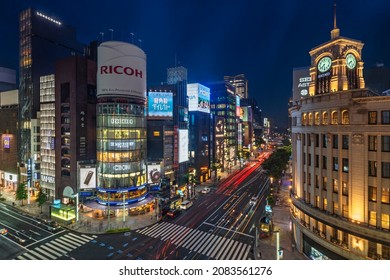 Tokyo, Japan - July 05 2021: Night Upper View Of The Clock Tower Of The Ginza Wako Building Illuminated And The Tower Of Sanai Dream Center At The Junction Of The Ginza 4-Chome Scramble Crossing.