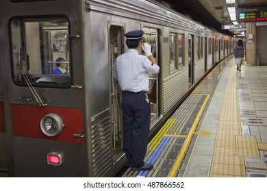 TOKYO, JAPAN - JULY 2014: Subway Line Conductor Signals At Station In Tokyo, Japan