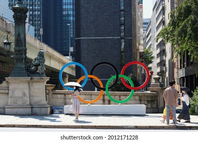 TOKYO, JAPAN - July 22, 2021:  Nihonbashi Bridge On A Hot Day With A Statue Of A Lion  And An Olympic Ring Monument.