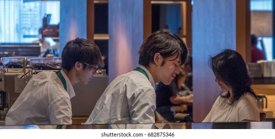 TOKYO, JAPAN - JULY 22TH, 2017. Starbucks Coffee House Counter Staff Entertaining Customers In Ginza 6 Snopping Complex.