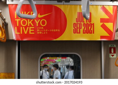 TOKYO, JAPAN - July 30, 2021: Poster Advertising Nike Tokyo Live Project Inside A Subway Train. More Posters Are Visible In The Background. Selective Focus.