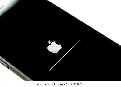 Tokyo, Japan - June 04 2019: Apple IPhone With IOS Upgrade Screen With Progress Bar On White Table.