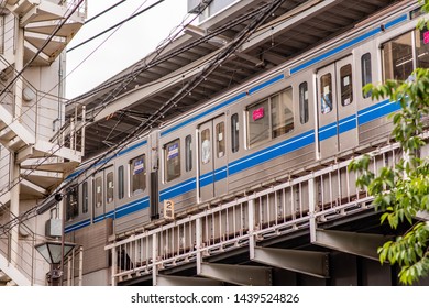 Tokyo, Japan - June 1, 2019: A Man Looks Down From A Subway Train In The Nakameguro Area Of Shibuya. The Area Is Known For Its Shopping And Dining And Is Only One Stop From Shibuya Proper.