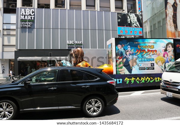 TOKYO, JAPAN - June 13, 2019: An advertising truck\
promoting \'The Seven Deadly Sins\', a smartphone game based on a\
manga, moving through traffic in Tokyo\'s Harajuku area. Some motion\
blur.