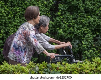 TOKYO, JAPAN - JUNE 15TH 2017. Elderly Japanese Women Walking In A Park. Japan Aging Population Is Purported To Have The Highest Proportion Of Elderly Citizens Compared To Other Countries.