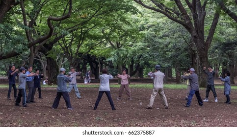 TOKYO, JAPAN - JUNE 18TH 2017. Elderly People Practising Taichi Yoyogi Park. The Park Is A Very Popular Public In Tokyo And Is A Favorite Destination For Recreational Activities In Tokyo.