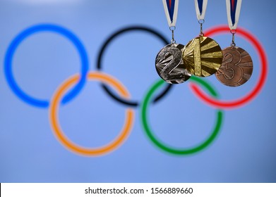 TOKYO, JAPAN, JUNE. 20. 2019: Gold, silver and Bronze medal, olympic logo in background