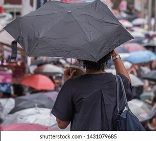 TOKYO, JAPAN - JUNE 21ST, 2019. Man With Umbrella In Takeshita Dori Street, Harajuku, During A Rainy Day.