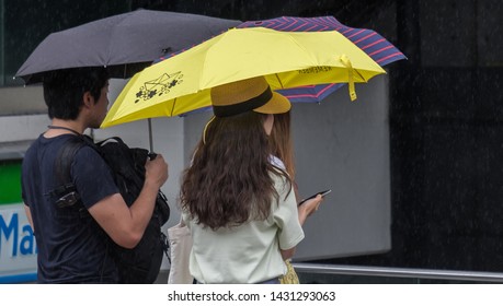 TOKYO, JAPAN  - JUNE 21ST, 2019. Couple With Umbrella During A Rainy Day At Takeshita Dori Street, Harajuku.