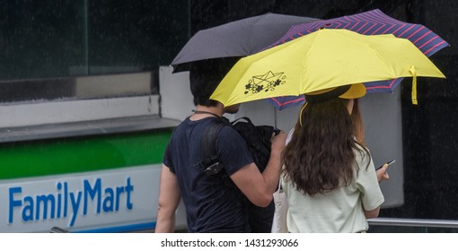 TOKYO, JAPAN  - JUNE 21ST, 2019. Couple With Umbrella During A Rainy Day At Takeshita Dori Street, Harajuku.