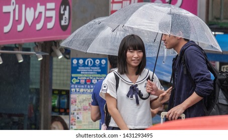 TOKYO, JAPAN  - JUNE 21ST, 2019. Couple With Umbrella During A Rainy Day At Takeshita Dori Street, Harajuku.