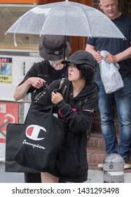 TOKYO, JAPAN  - JUNE 21ST, 2019. Couple With Umbrella During A Rainy Day At Takeshita Dori Street, Harajuku.