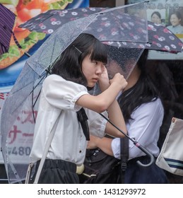 TOKYO, JAPAN  - JUNE 21ST, 2019. Young Girl With Umbrella During A Rainy Day At Takeshita Dori Street, Harajuku.